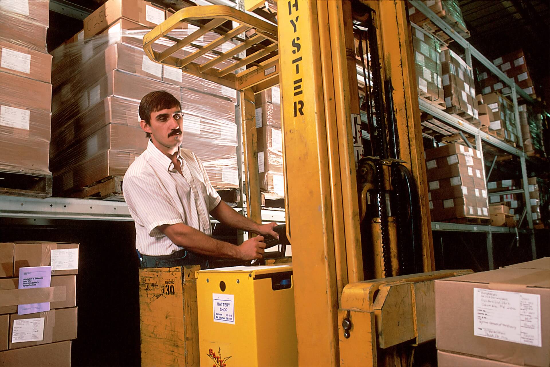 Man loading tyres using forklift